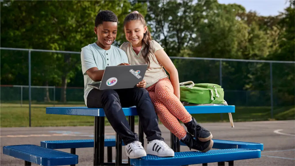 Students looking at a laptop for online learning.