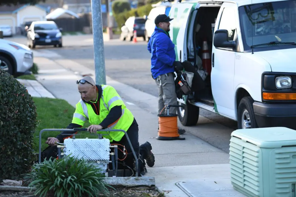 Xfinity techs connecting a home to high speed internet.