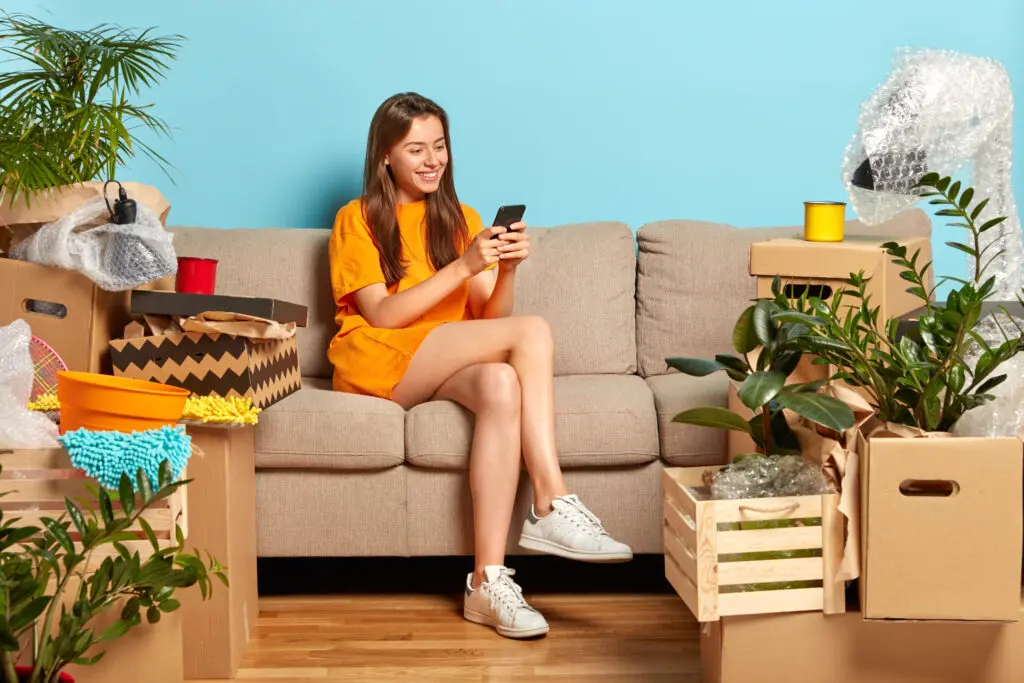 A young woman moving easily signed up for Xfinity Internet at their new home with the the help of an easy checklist for moving in MIchigan.