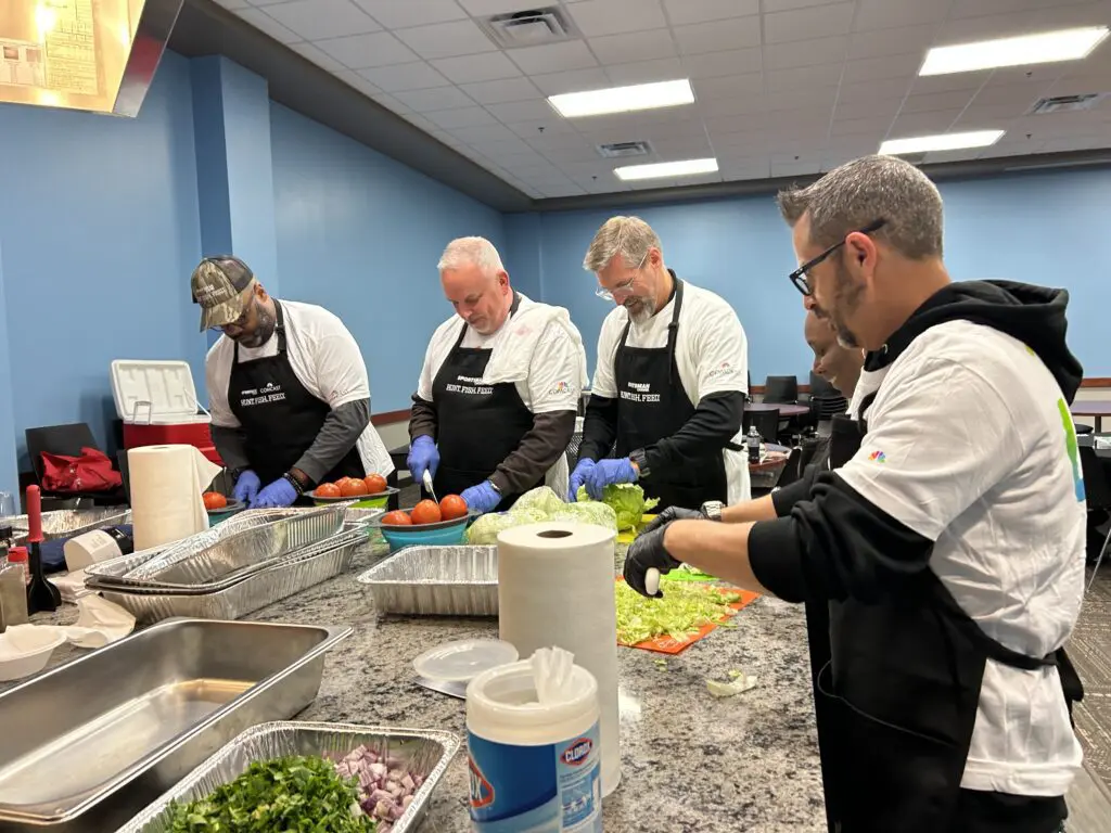 Comcast volunteers assisted professional chef Paul Comes with preparing and serving the meal.