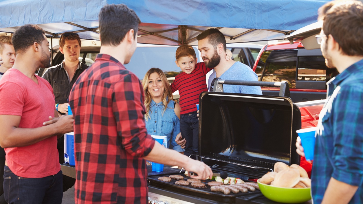 People gathered around a grill