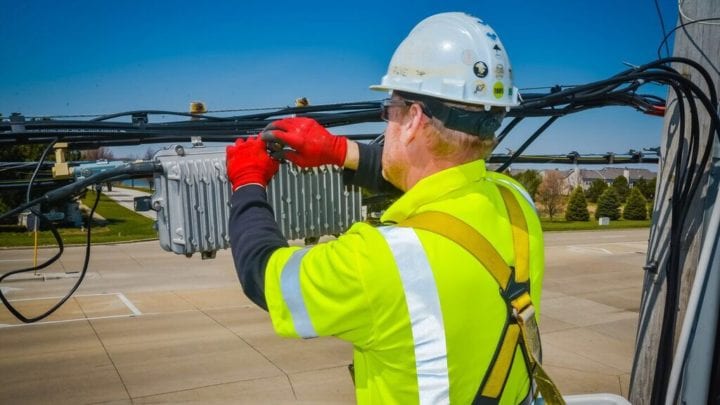 An Xfinity technician fixes a cable.