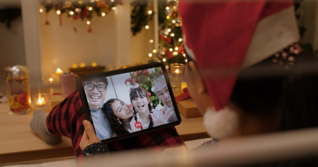 Tablet showing virtual holiday gathering with family connecting online while sharing Black Friday savings tips.